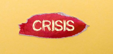 Sarı arka planda, üzerinde CRISIS yazan kırmızı bir sayfa.
