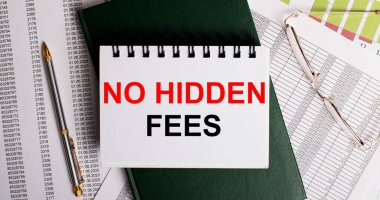 Masaüstünde raporlar, gözlükler, bir kalem, yeşil bir günlük ve üzerinde HAYIR ödemeleri yazan beyaz bir defter var. İş yeri, yakın çekim. İş konsepti