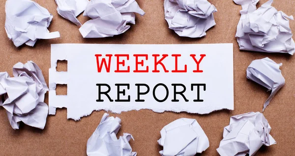 WEEKLY REPORT written on white paper on a light brown background.