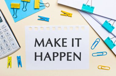 Hafif bir arka planda, bir yığın belge, bir beyaz hesap makinesi, sarı ve mavi ataçlar ve mandallar, ve bir not defteri var.