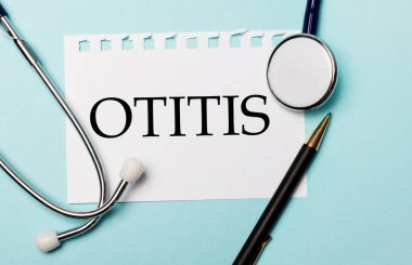 Açık mavi bir arkaplanda, steteskop, bir kalem ve yazılı bir kağıt. Tıbbi konsept