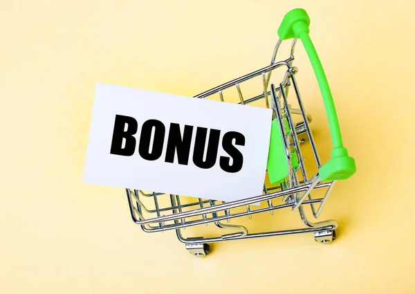 The card with the word BONUS is in the shopping cart. Marketing concept