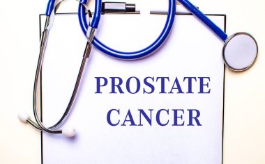 The words PROSTATE CANCER is written on a white sheet near the stethoscope. Medical concept