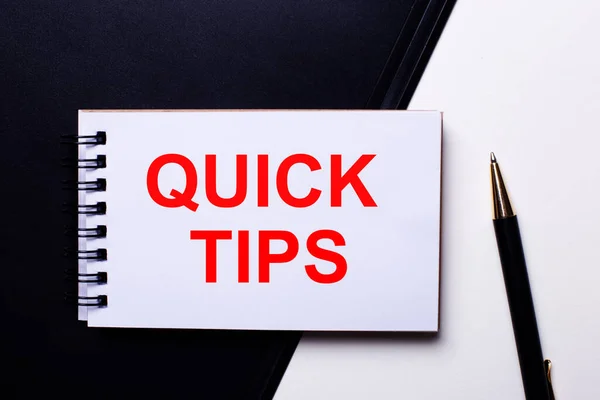 The words QUICK TIPS written in red on a black and white background near the pen