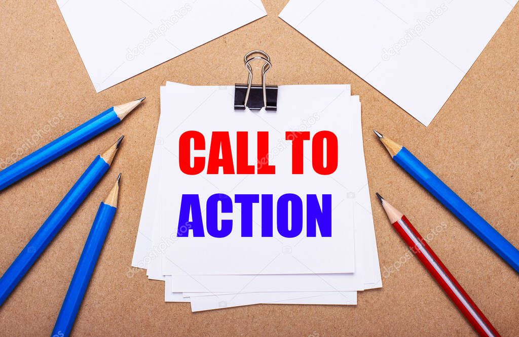 On a light brown background, blue and red pencils and white paper with the text CALL TO ACTION