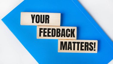 Açık gri arka planda mavi bir defter var. Üzerinde 