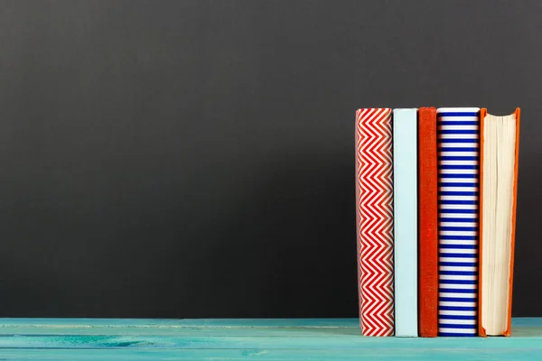 Composition with old vintage colorful hardback books, diary on wooden background — ストック写真