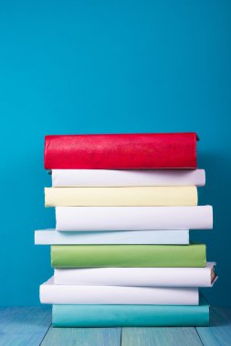 Book in library on blue wooden shelf. Education background with copy space for text. Toned photo