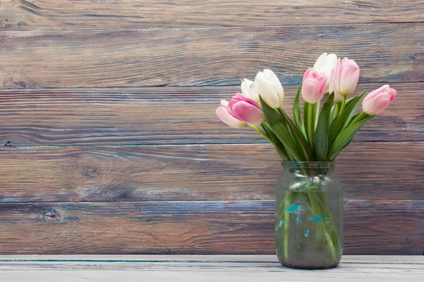 Colorful tulips flowers on wooden table. Top view with copy space. Toned picture by instagram filter — Stock Photo, Image