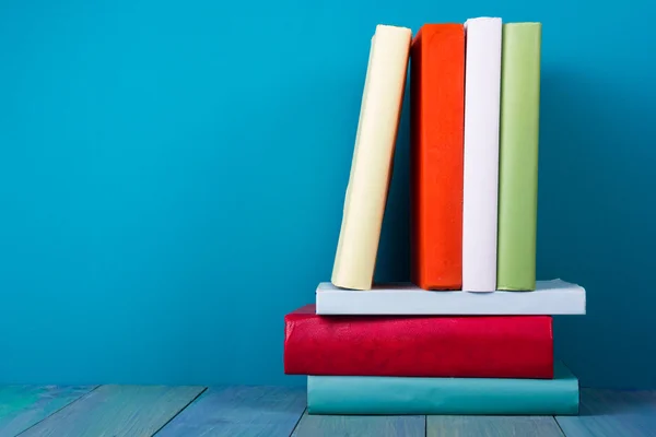 Book in library on blue wooden shelf. Education background with copy space for text. Toned photo — Φωτογραφία Αρχείου