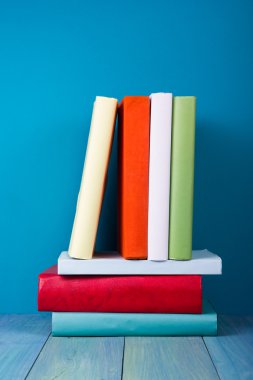 Book in library on blue wooden shelf. Education background with copy space for text. Toned photo