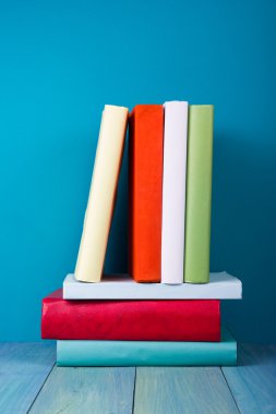 Book in library on blue wooden shelf. Education background with copy space for text. Toned photo