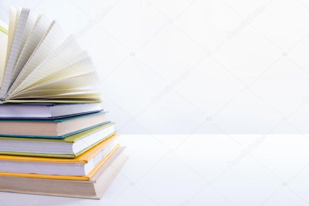 A stack of colorful books, open book. Back to school