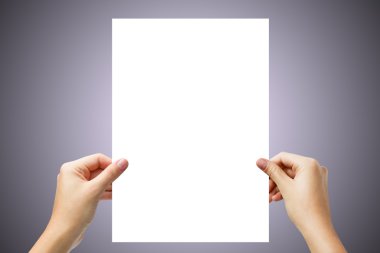 Hands holding a white paper blank isolated on purple background