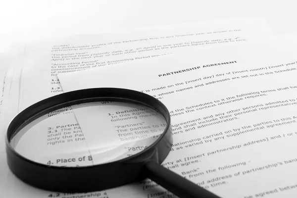 Stack of books with magnifying glass. Search information. — Stock Photo, Image