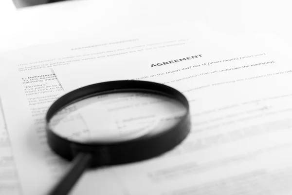 Stack of books with magnifying glass. Search information. — Stock Photo, Image