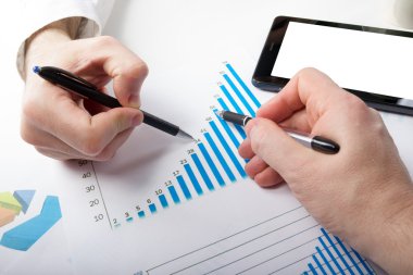 Business people on meeting analyzing financial reports, teamwork