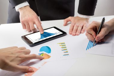 Business people on a meeting analyzing financial reports