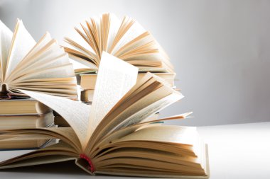 Books. Back to school. Composition with hardback books on the table. Open book, fanned pages. Copy space. Education background.