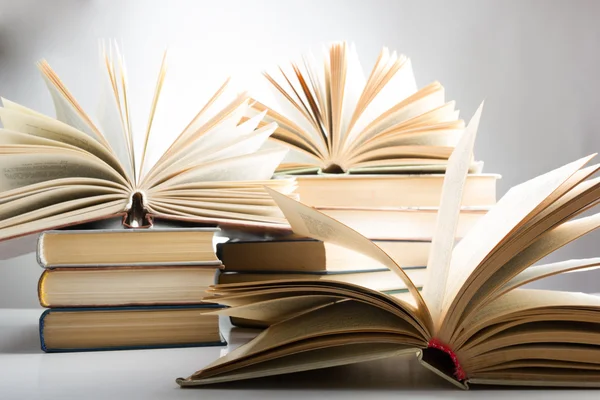 Books. Back to school. Composition with hardback books on the table. Open book, fanned pages. Copy space. Education background.