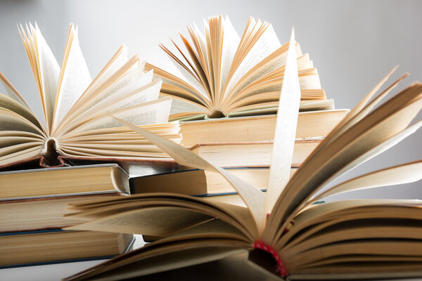 Books. Back to school. Composition with hardback books on the table. Open book, fanned pages. Copy space. Education background.