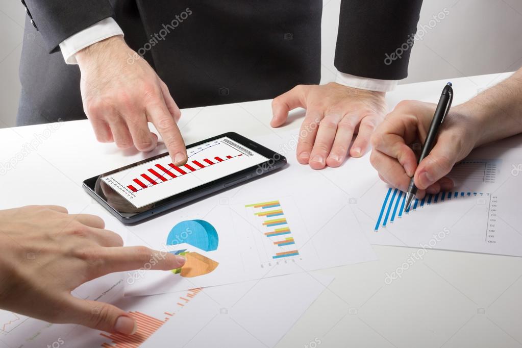 Business people on a meeting analyzing financial reports