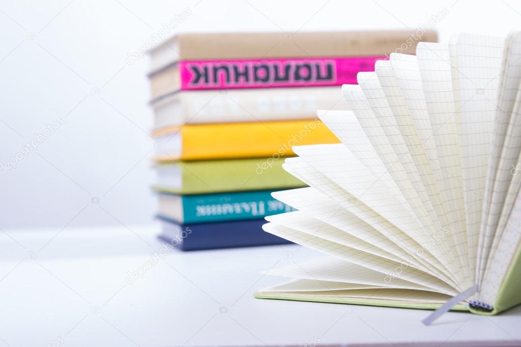 A stack of colorful books, open book. Back to school