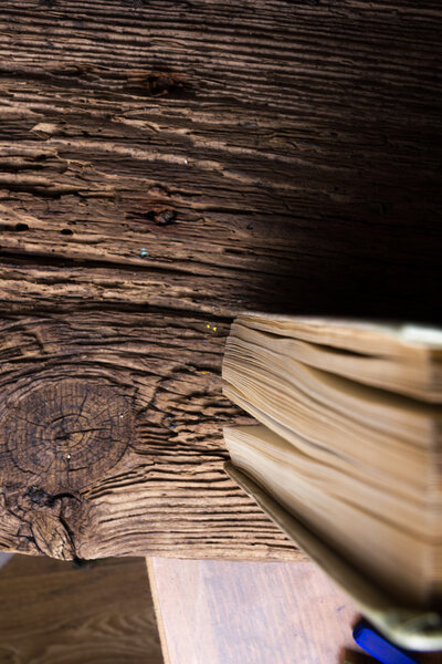 Top view of old book stack over old grunge natural wooden shabby