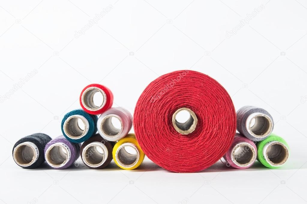 Thread on white background.  Colorful spools of thread. Sewing background