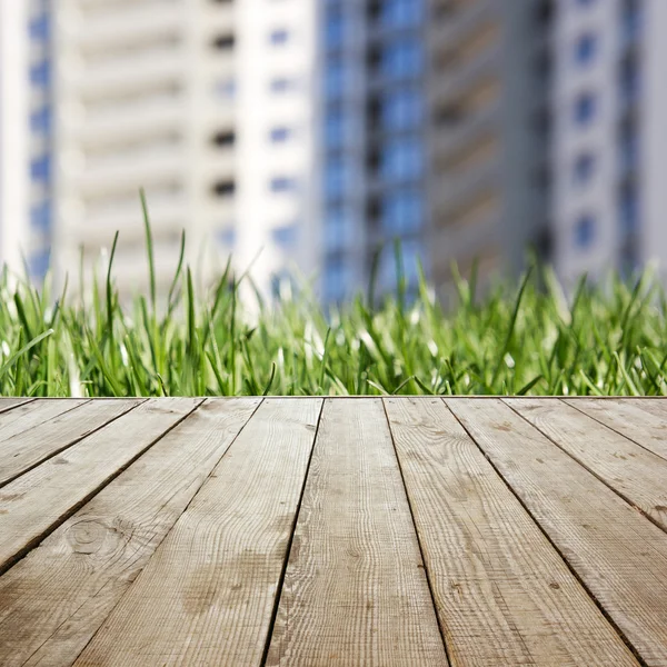 Piso de perspectiva de madera con tablones en bienes raíces de hierba borrosa —  Fotos de Stock