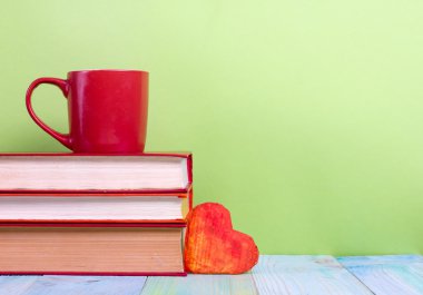 Back to school. Composition with old vintage hardback books and red cup, heart, pencils clipart