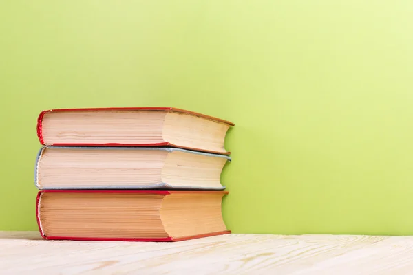 Composition with vintage old hardback books, diary on wooden table green background — ストック写真