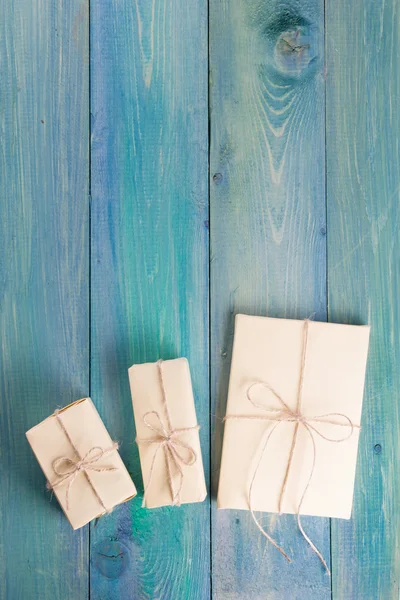 Festive present boxes with ribbon on turquoise painted wooden background. Place for text. Selective focus. — Zdjęcie stockowe