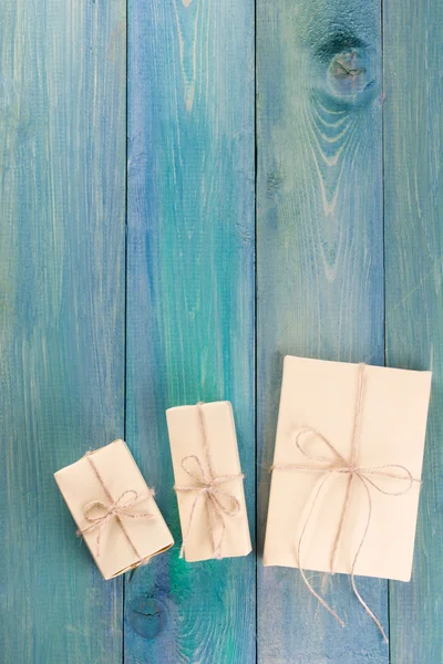 Festive present boxes with ribbon on green painted wooden background. Place for text. Selective focus. — Zdjęcie stockowe