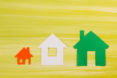 Real Estate Concept. Paper house against green background. Real Estate Concept. Top view. Ecological house, copy space for text.