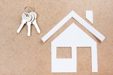 Real Estate Concept Paper model house against wooden background. Ecological building. Top view.