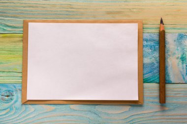 Top view of blank note book, calendar with colorful pencils. Back to school, copy space. Education wooden background. Artistic, artist, art