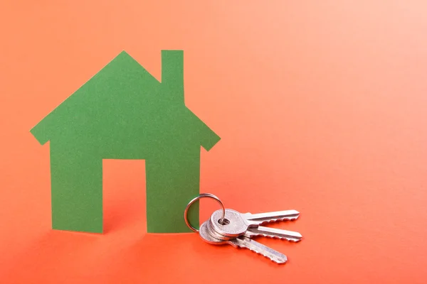 Real Estate Concept Paper model house against red background. Ecological building. Top view. — Stock Photo, Image