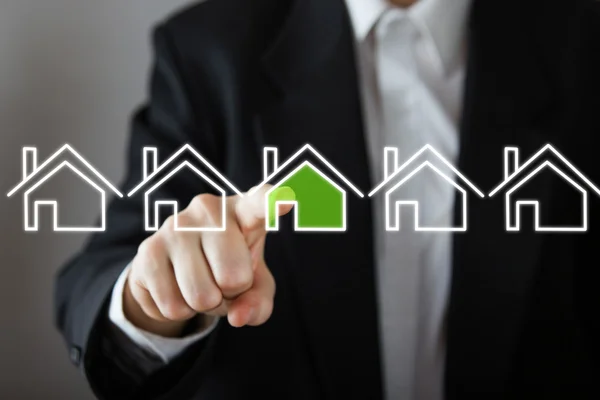 Businessman choosing house, real estate concept. Hand pressing the house icon. Copy space. — Stock Photo, Image