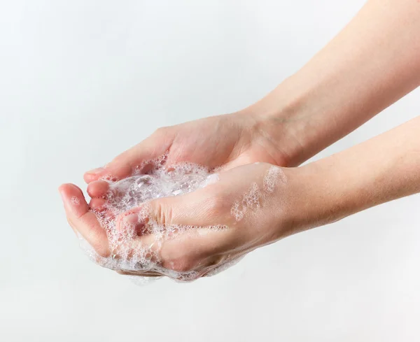 Gesto di donna che si lava le mani su sfondo bianco — Foto Stock