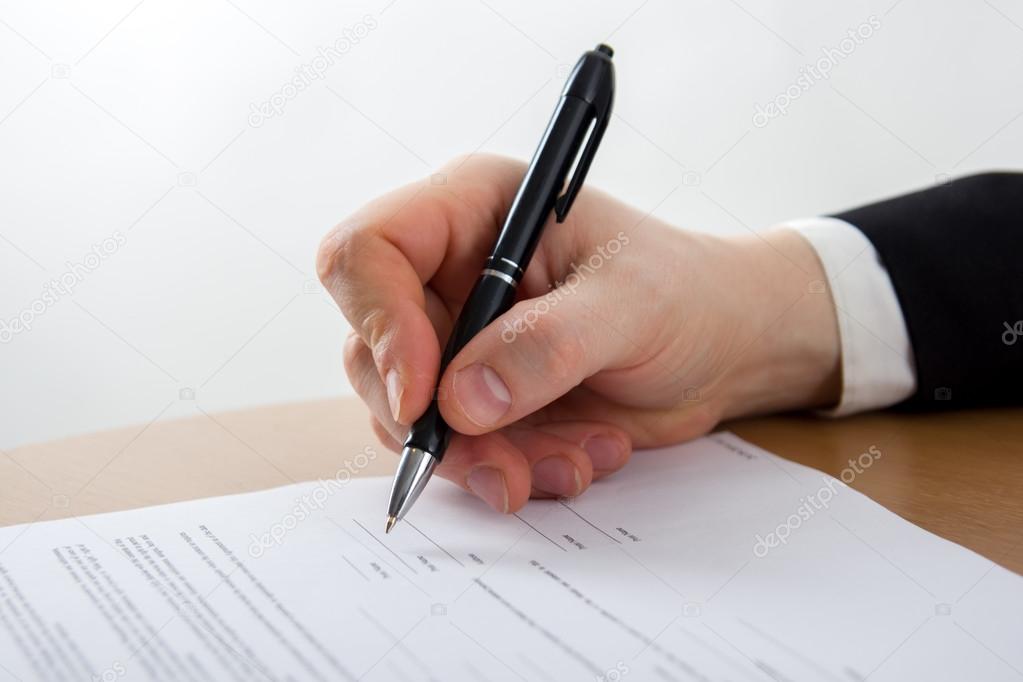 Businessmans hand signing papers. Lawyer, realtor, businessman