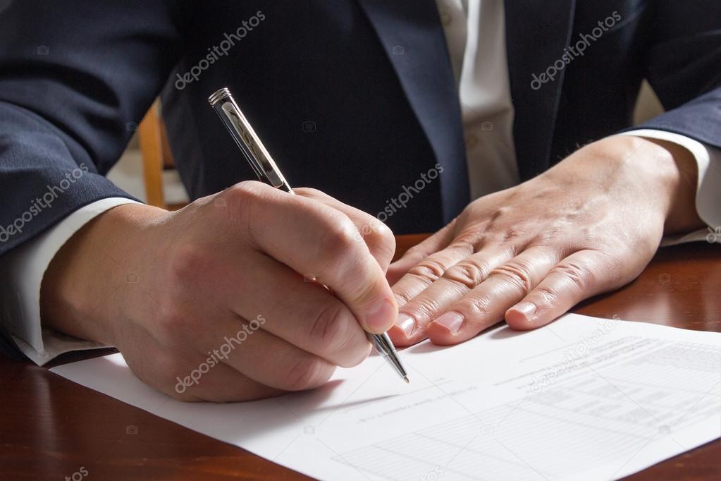 Businessmans hand signing papers. Lawyer, realtor, businessman