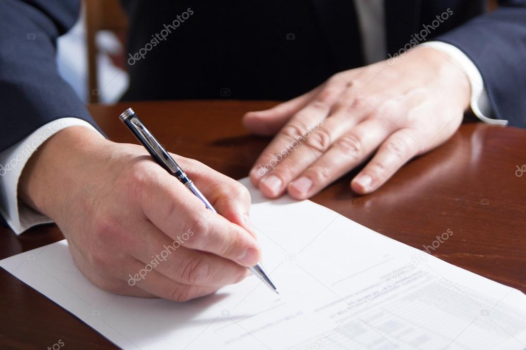 Businessmans hand signing papers. Lawyer, realtor, businessman