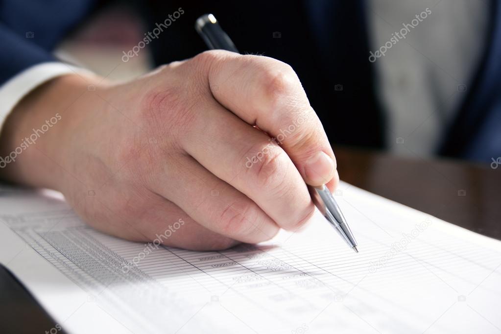 Businessmans hand signing papers. Lawyer, realtor, businessman