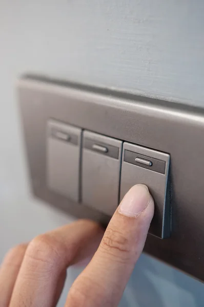 Finger is turning light switch. — Stock Photo, Image