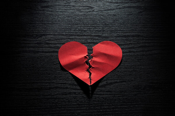 red hearts crumpled paper on dark wood background