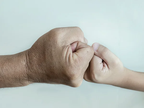 Close up of two fists hitting of a man and a boy. — Stock Photo, Image