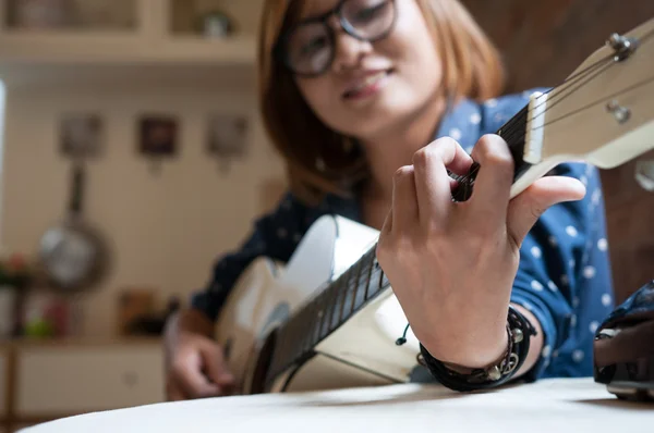 Menina asiática está tocando a guitarra . — Fotografia de Stock