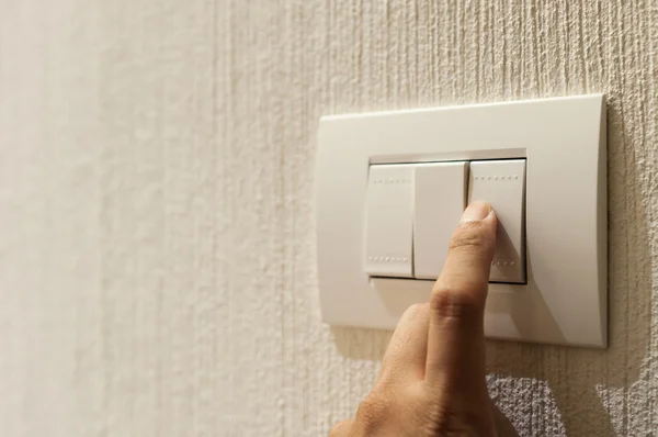 Closeup of finger is turning on a lighting switch — Stock Photo, Image