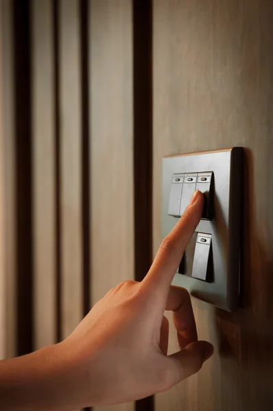 Light switch on wooden blackground. — Stock Photo, Image